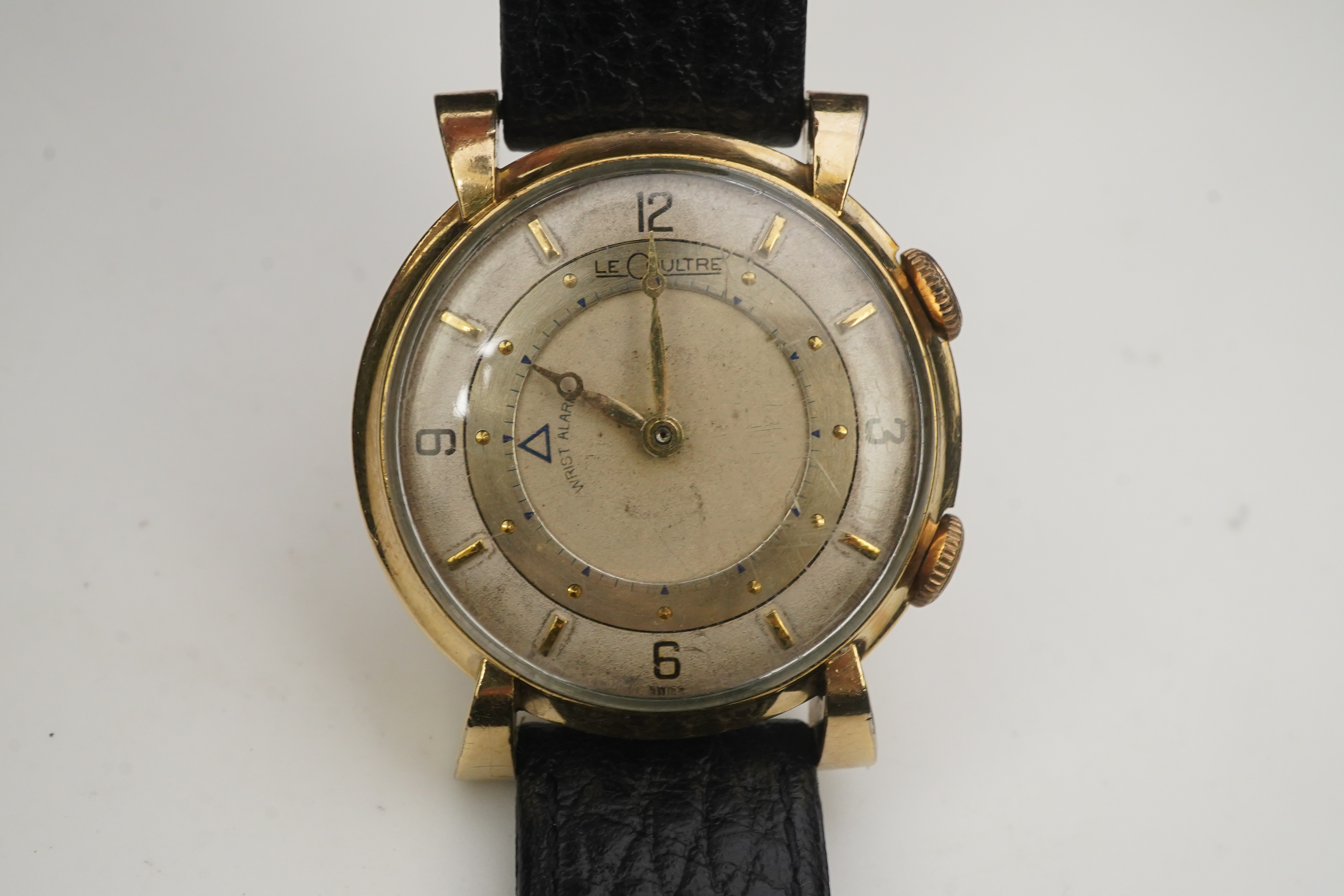 A gentleman's 1950's? 10k gold filled Jaeger LeCoultre Memovox manual wind wrist watch, on a later associated leather strap